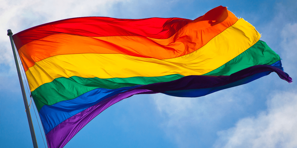 A rainbow flag blows in the wind