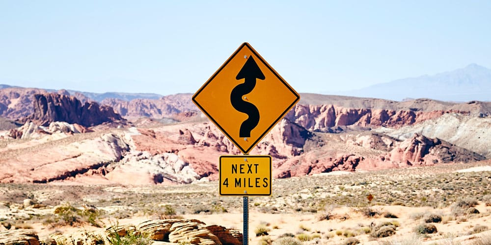 sign showing curvy road ahead