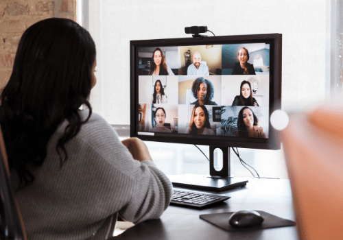 Woman looks at online meeting on computer