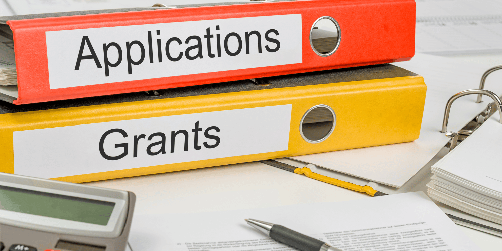 binders labeled grants and applications