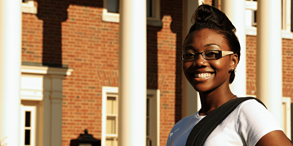 Black female student outside building with columns